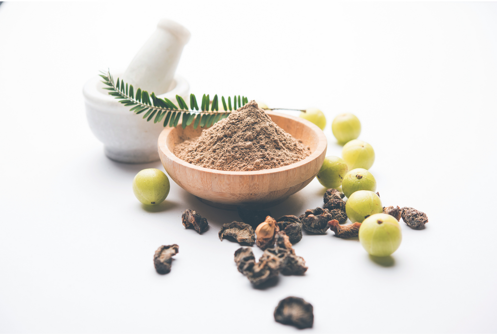 Wooden bowl with powder, Amla and dried Amla.